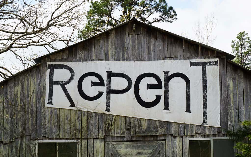 "Repent" banner on side of a barn