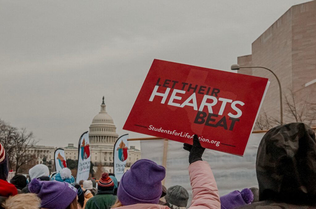 A prolife sign is shown being held up.