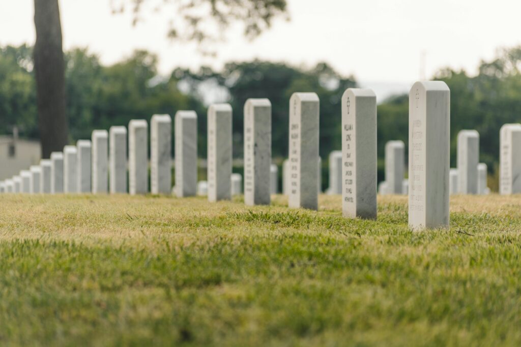 Tombstones of white marble in a graveyard.