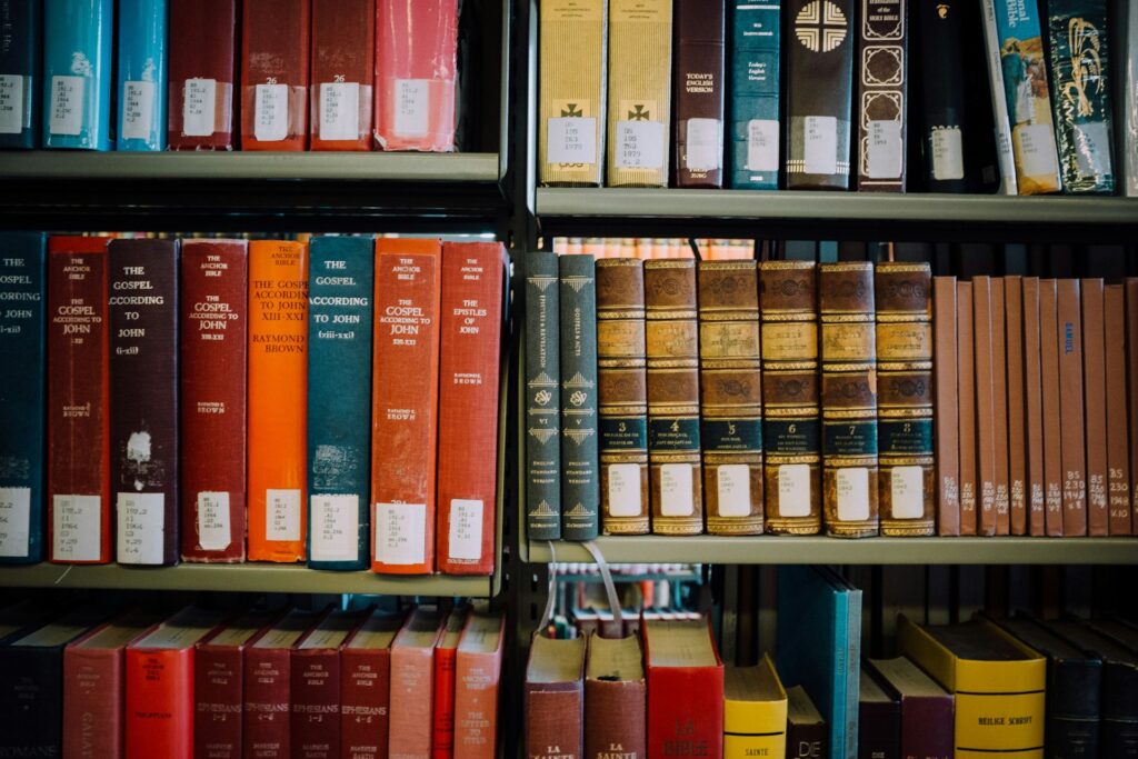 Theology books on a library shelf.