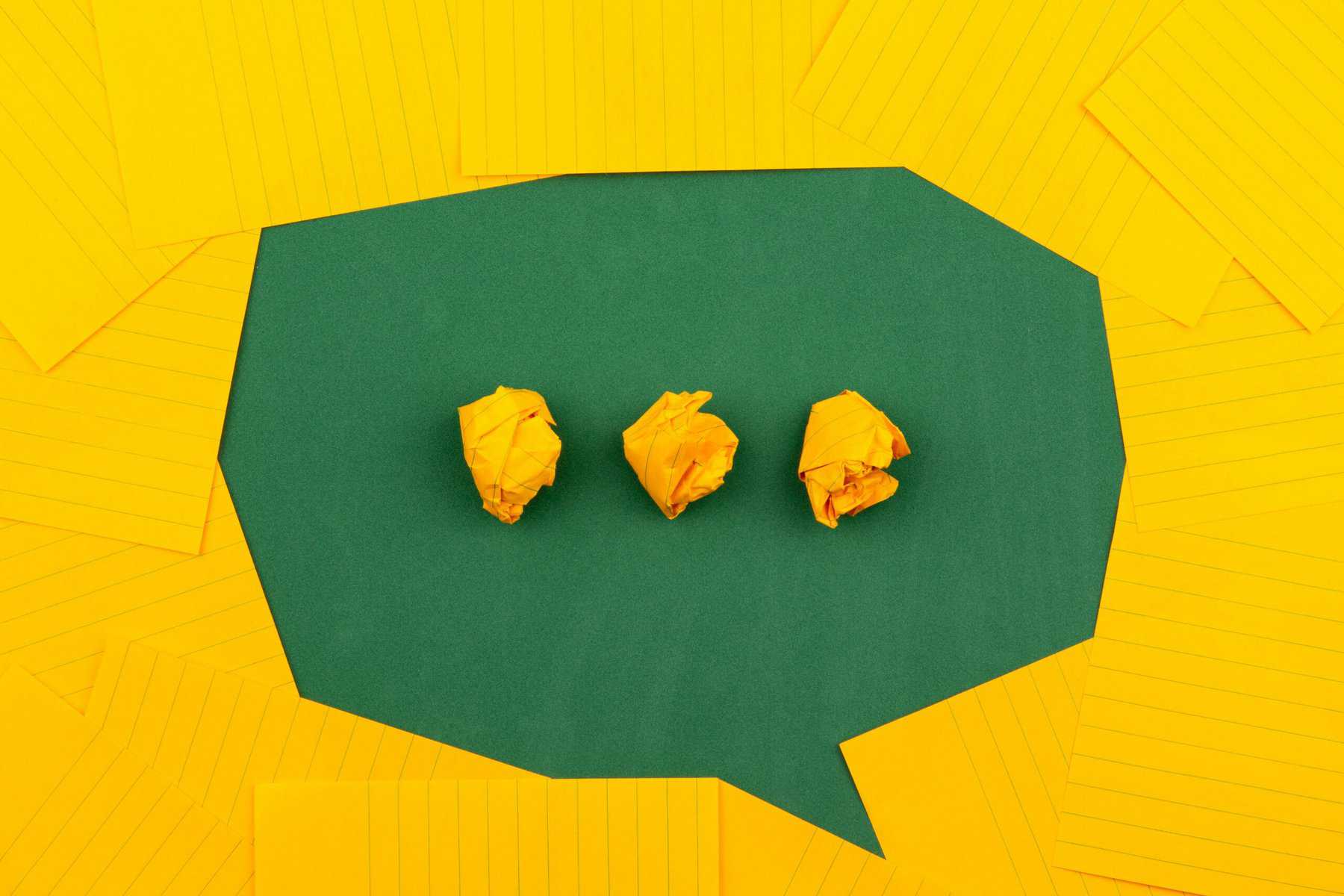 Yellow and green paper are used to create a green speech bubble with yellow paper ellipses.