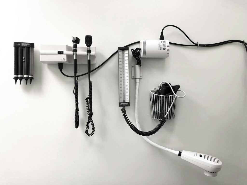 Typical medical tools and devices mounted on an exam room wall.