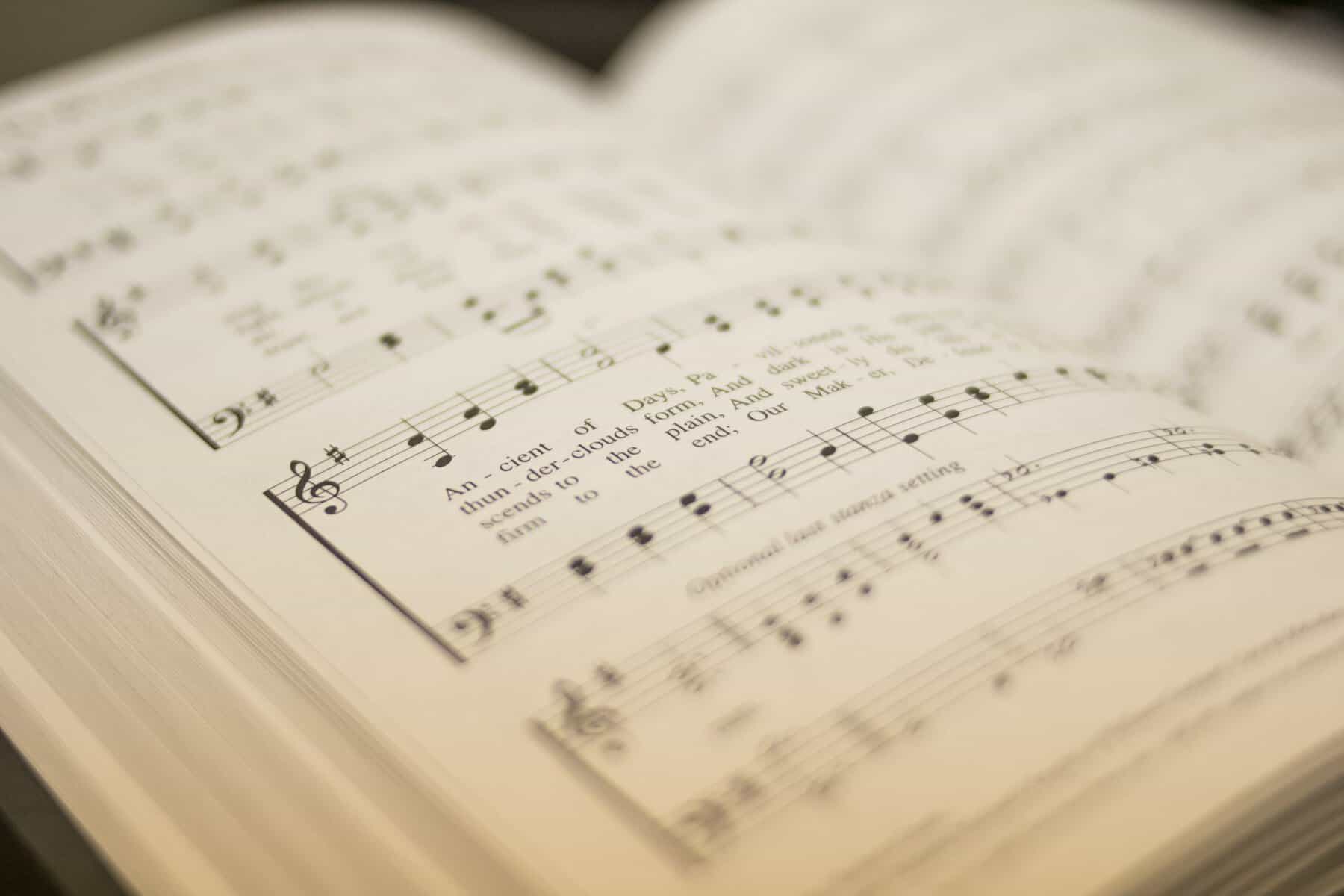 An open hymnal with a shallow depth of field.