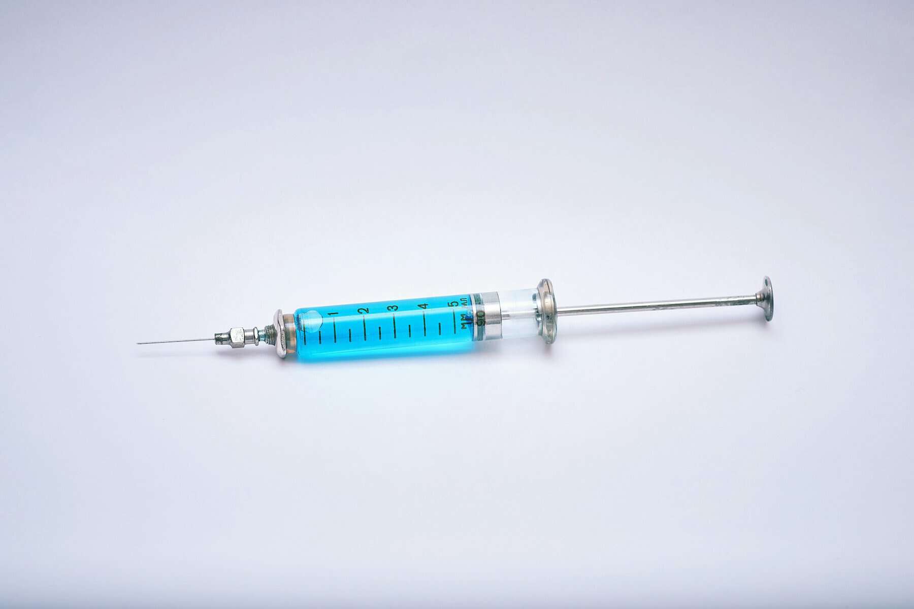 A blue liquid in a syringe.