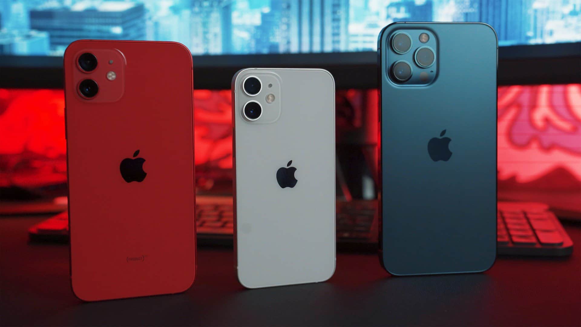 Three iPhones in different colors on end.