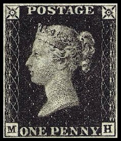 A postage stamp with the face of a woman wearing a crown on a black background.