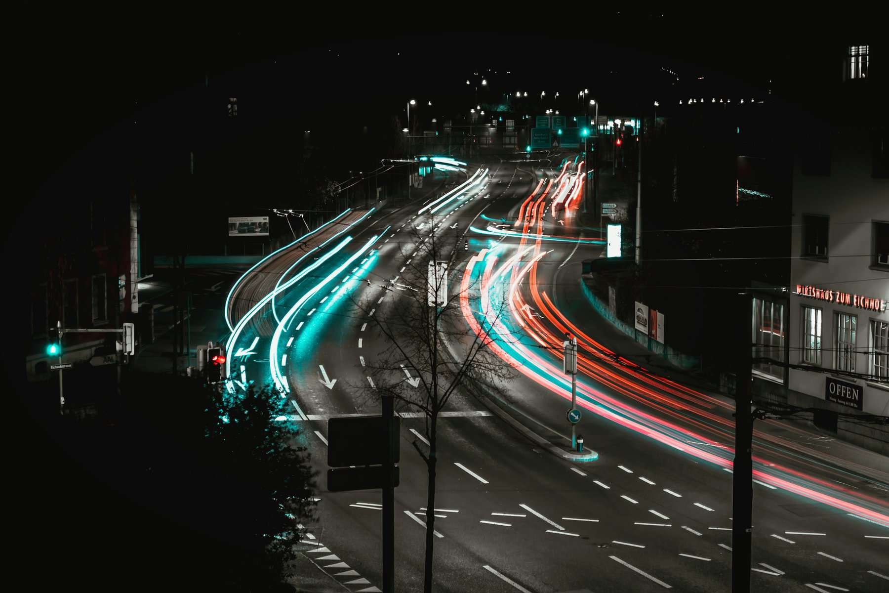 Slow shutter speed image showing automobile light trails at night on an road in Switzerland.