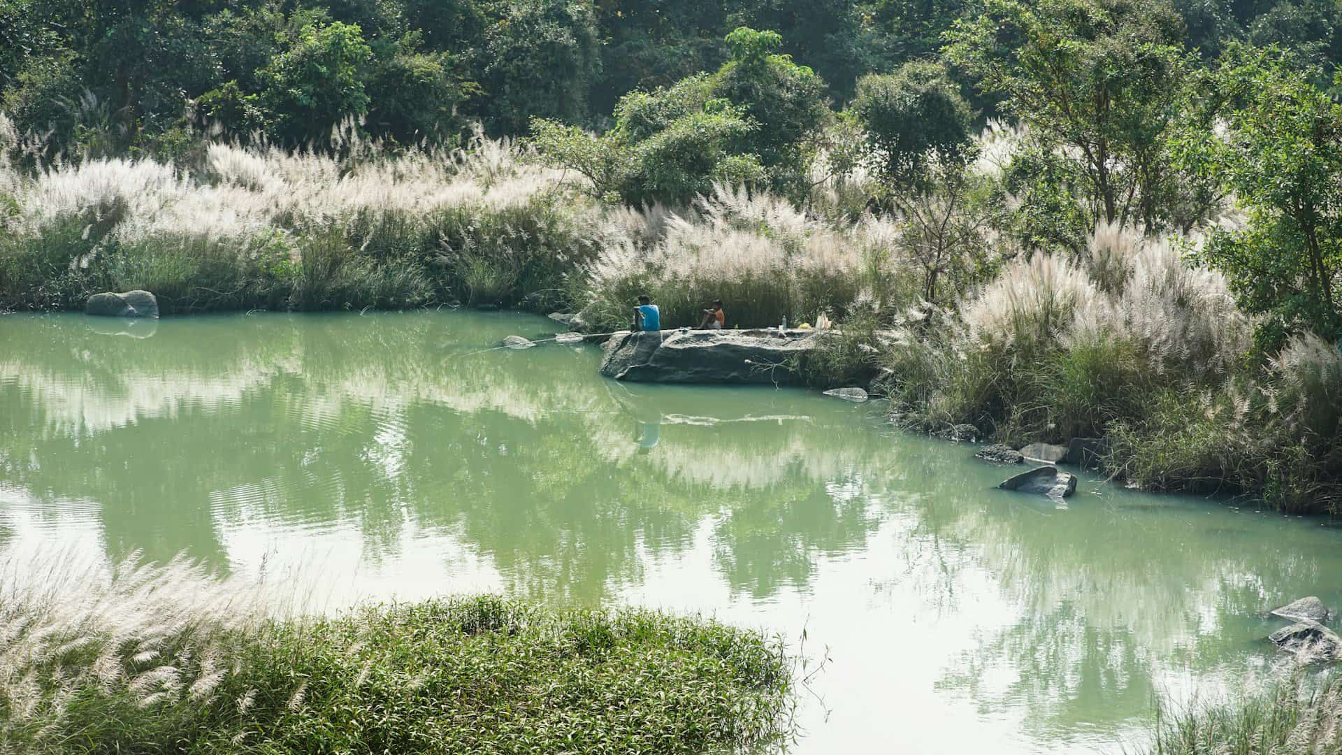 Two people by a water in Chhattisgarh.