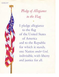 A poster with the Pledge of Allegiance next to the American flag.