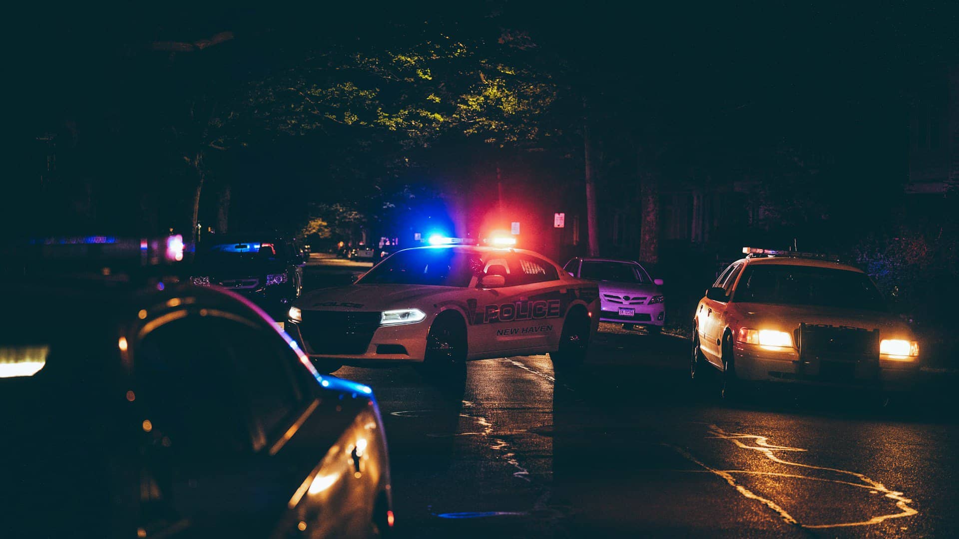 A police car with lights on at night.