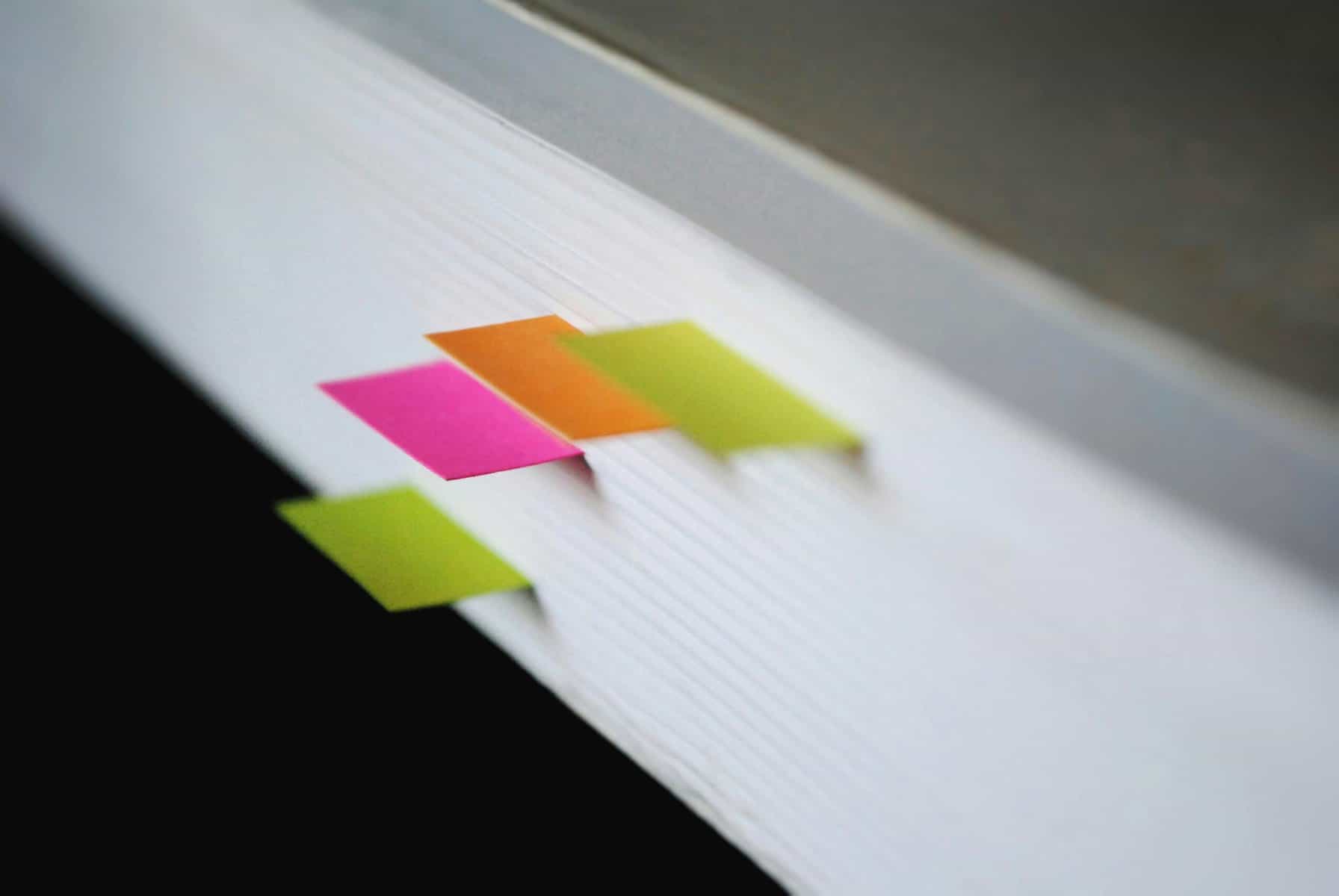 Report with post it tags along edge.