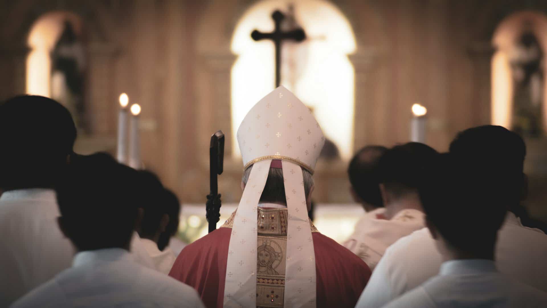 A man with a Bishops hat walks away from the camera.