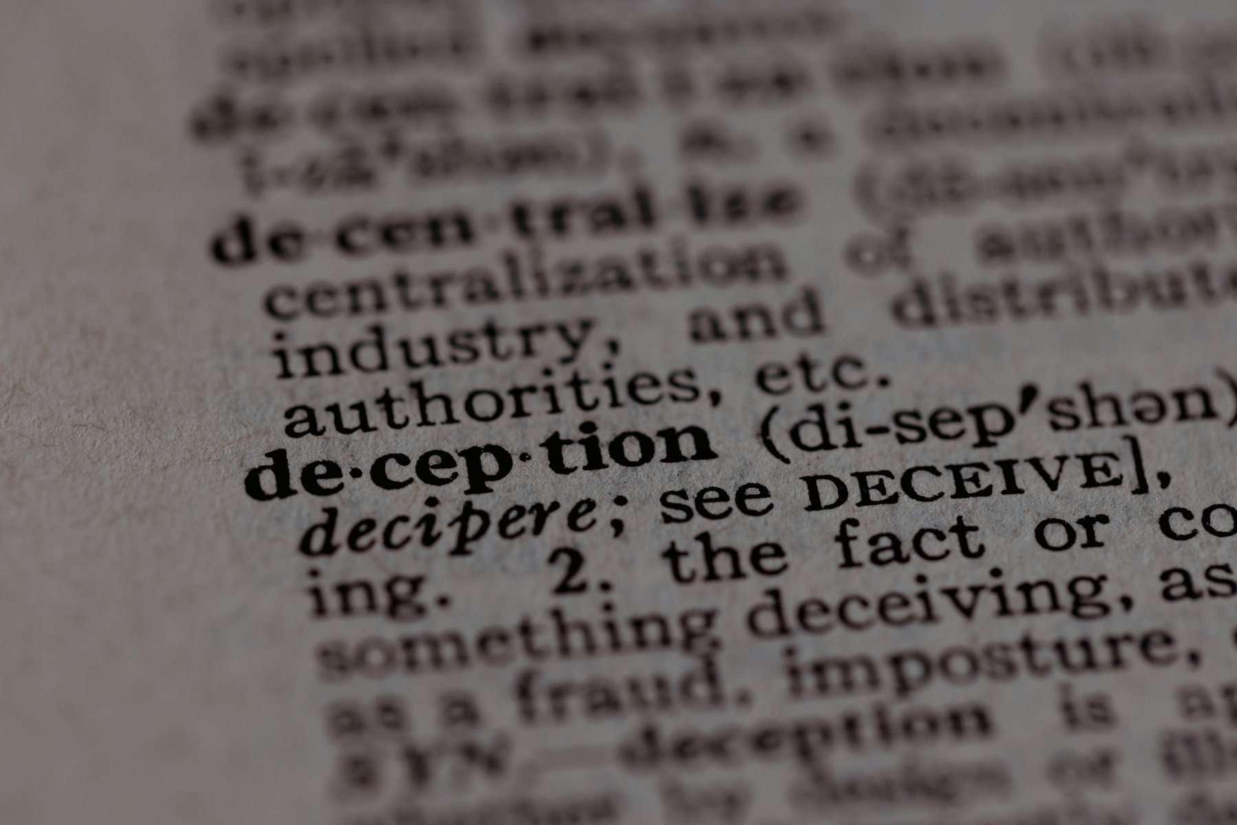 The word deception written in a dictionary.