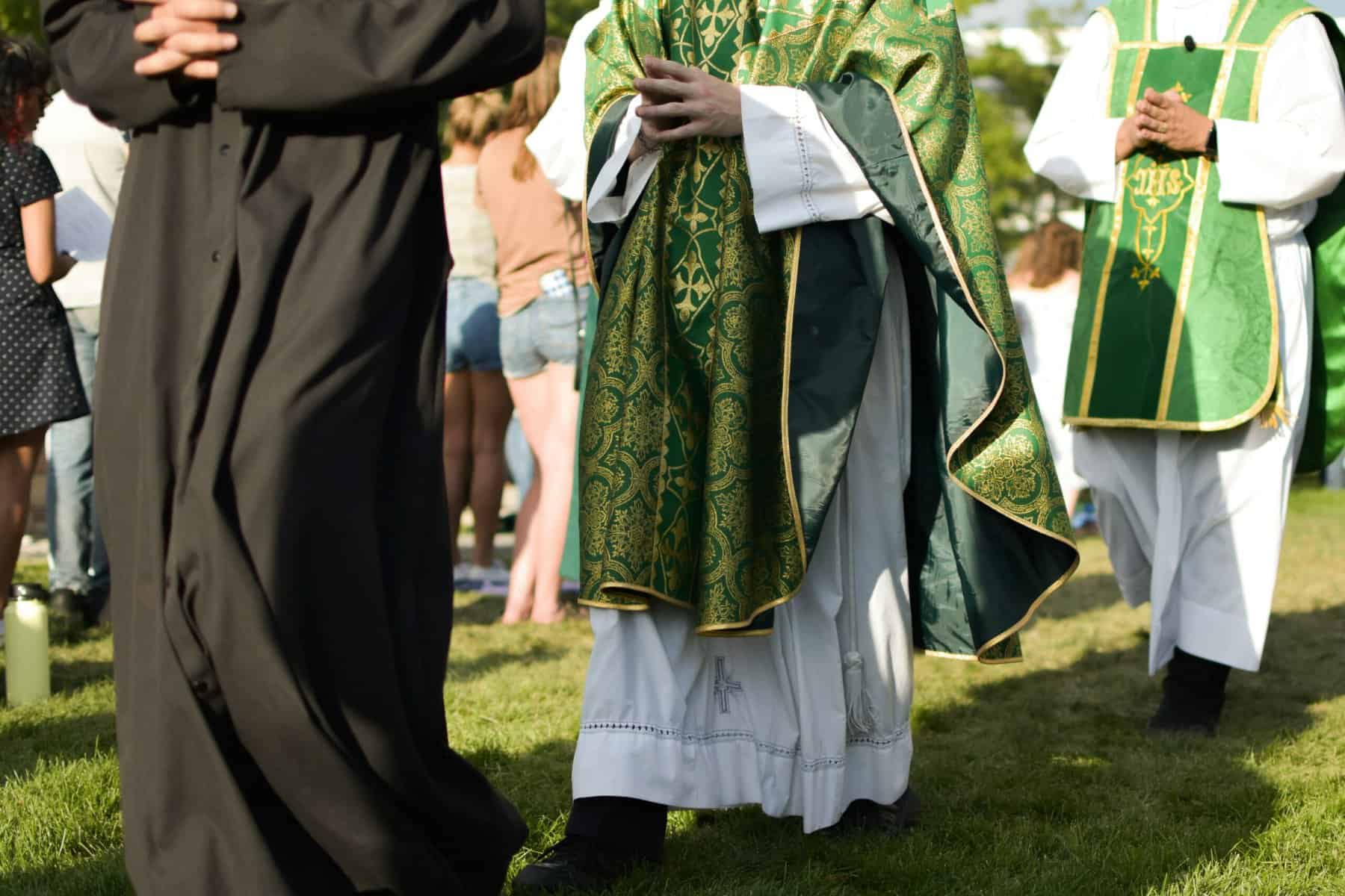 Robed clergy from the waist down.