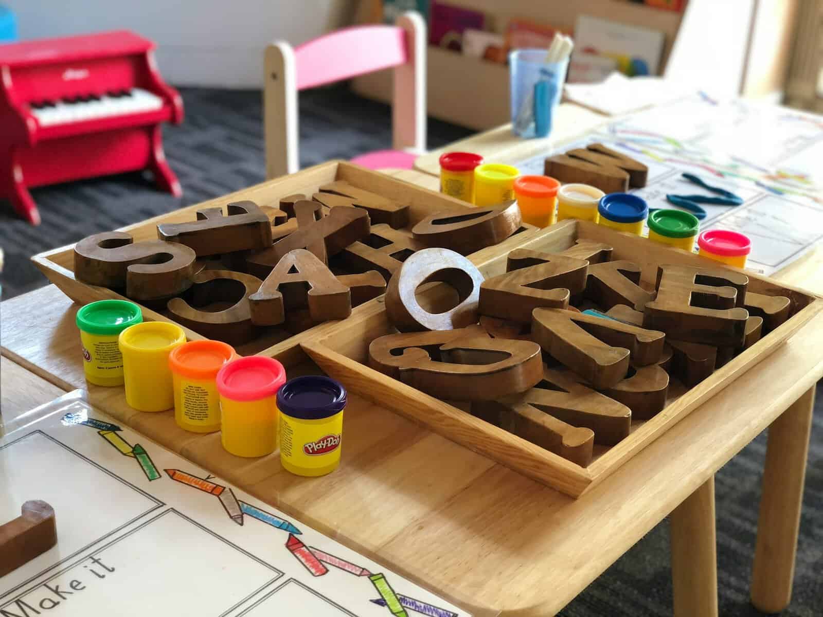 A preschool classroom with block letters and playdoh.