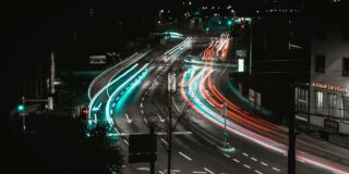 Slow shutter speed image showing automobile light trails at night on an road in Switzerland.