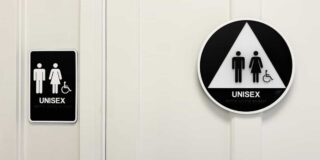 Unisex bathroom sign on a white door.