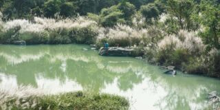 Two people by a water in Chhattisgarh.