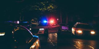 A police car with lights on at night.