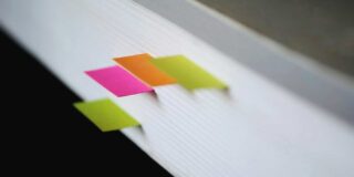 Report with post it tags along edge.