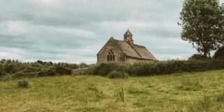 Old stone church in a field in England.