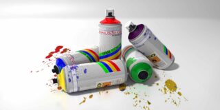 Pile of five spray paint cans knocked over with splattered paint