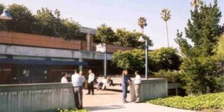 Graduate Theological Union library with people talking in front