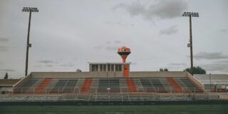 An empty high school football stadium.