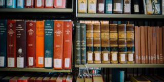 Theology books on a library shelf.