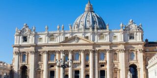 Street view of a domed building in the Vatican.