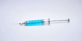 A blue liquid in a syringe.