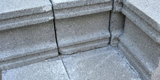 Cinder blocks stacked and forming a corner.