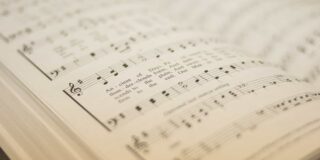 An open hymnal with a shallow depth of field.